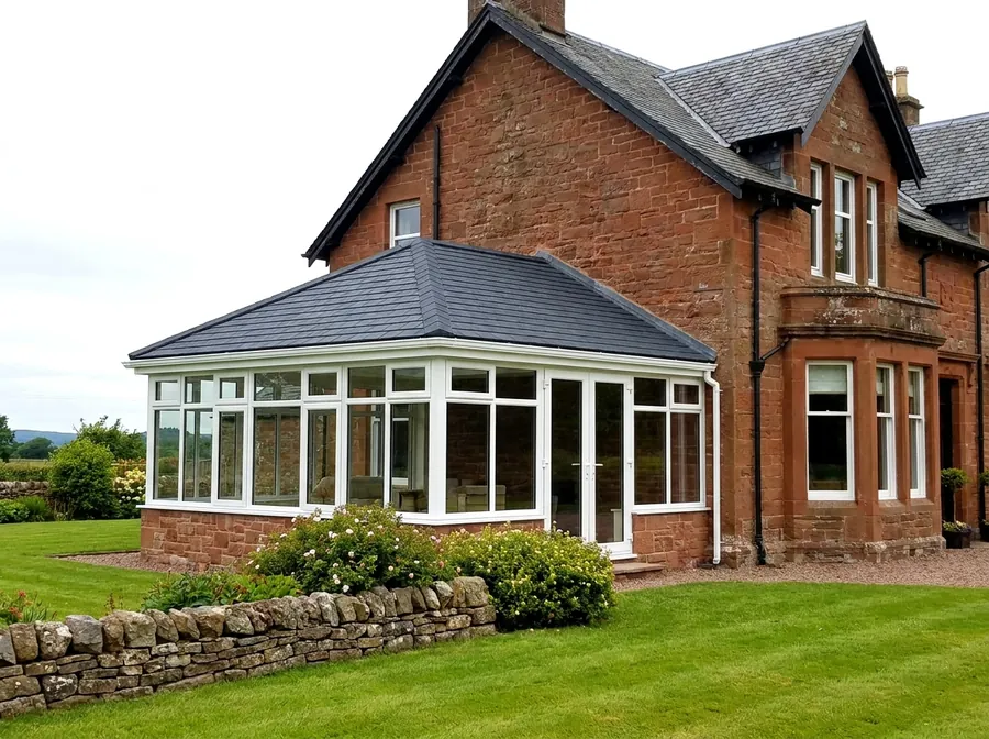 New charcoal slate-effect tiled conservatory roof on a red sandstone Scottish house