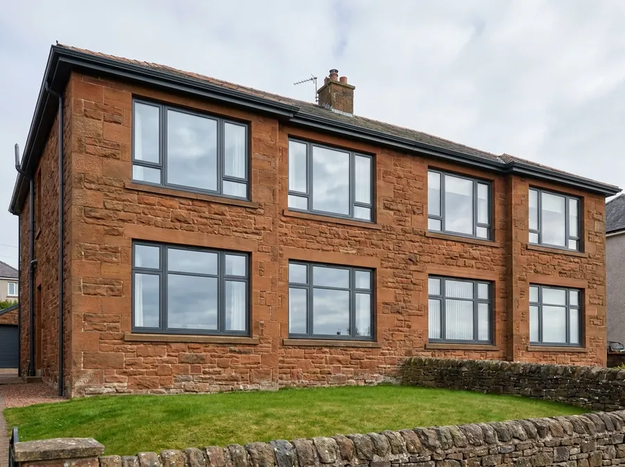 Brand new anthracite grey aluminium windows on a red sandstone Scottish semi