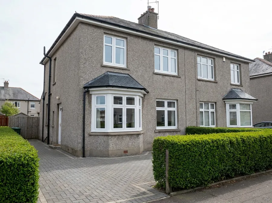 New white uPVC casement and bay windows on a pebble-dashed Scottish semi